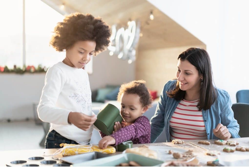 Children baking cookies with Childcarer