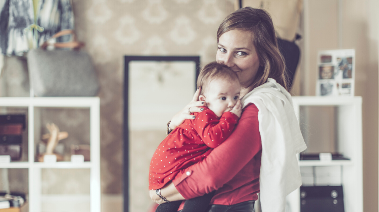 Babysitter holding a baby