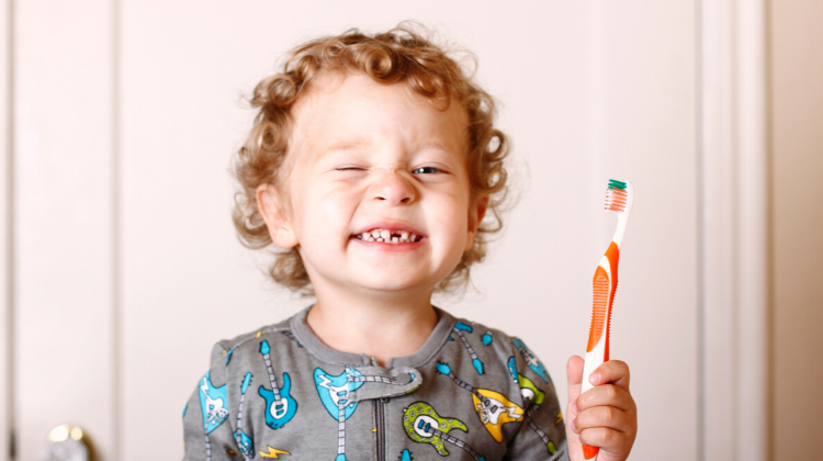 Small boy holding a toothbrush